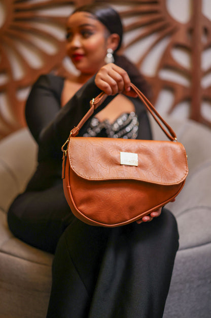 Denri Africa's spice Montana Sling Bag. Deep spice sling, portable crossbody bag, everyday use.