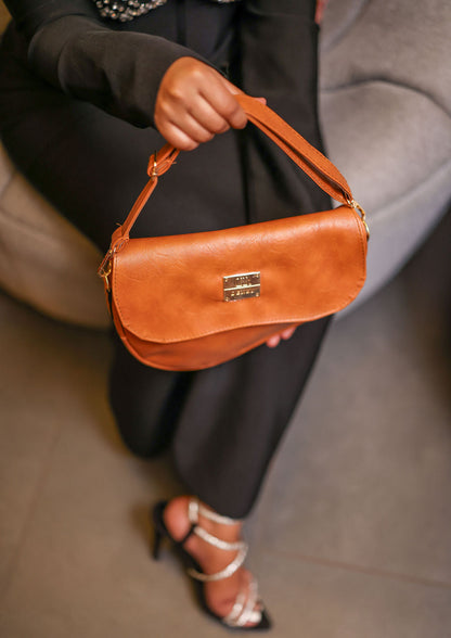 Denri Africa's spice Montana Sling Bag. Warm earthy sling bag, compact vegan leather carry.