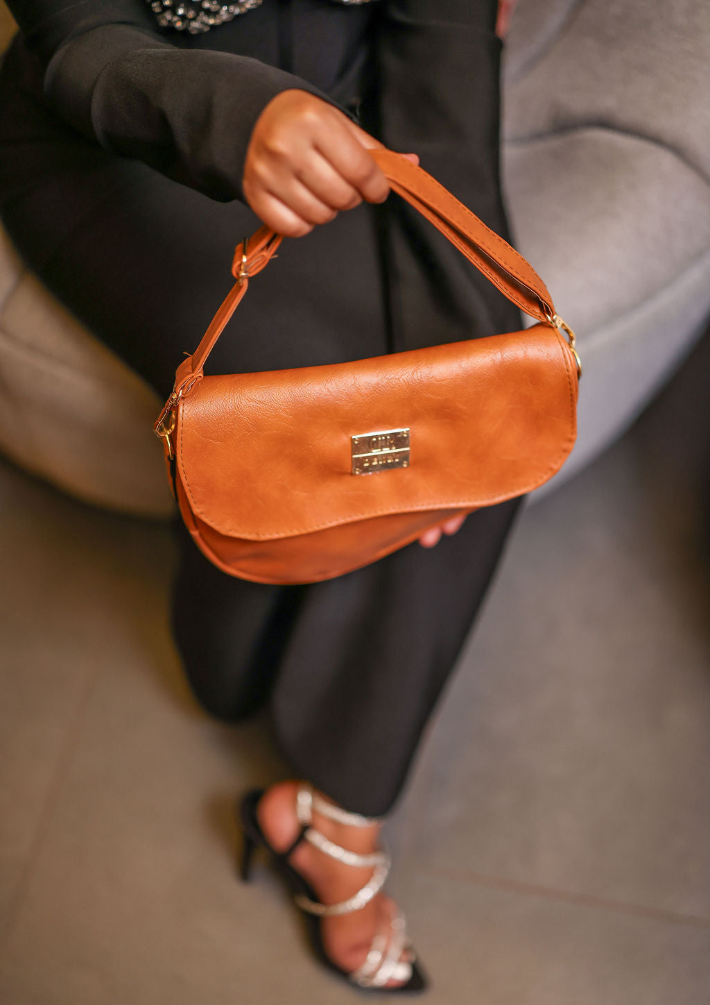 Denri Africa's spice Montana Sling Bag. Beautiful spice brown sling bag, modern vegan leather design.