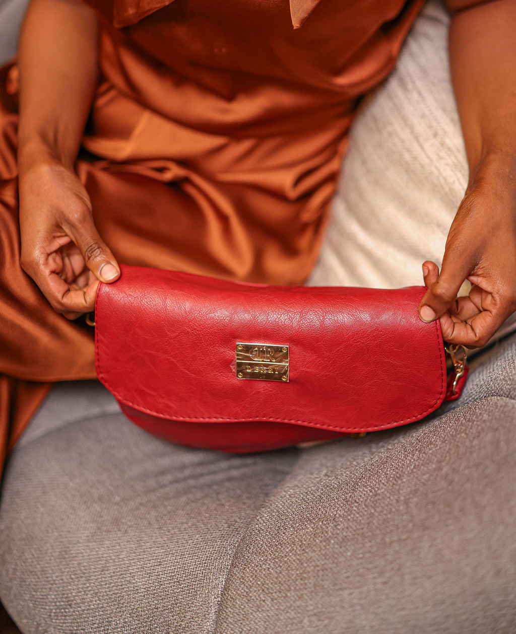 Denri Africa's red Montana Sling Bag. Contemporary red sling, sleek vegan leather, everyday lifestyle bag.