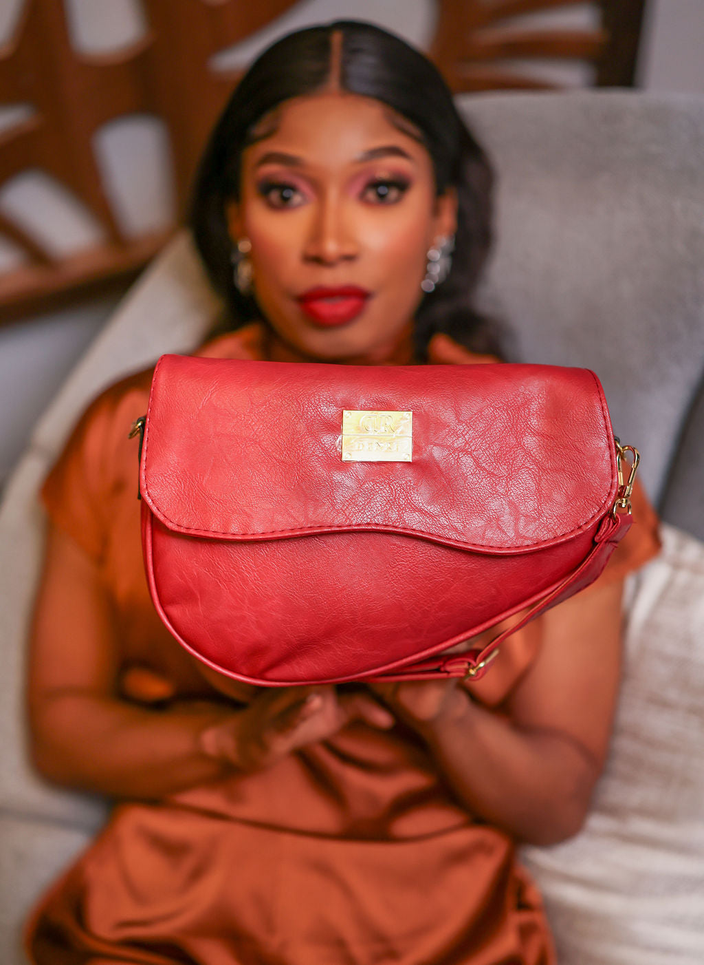 Denri Africa's red Montana Sling Bag. Chic red mini sling, durable vegan leather, perfect for errands and casual outings.