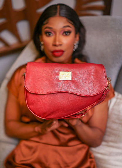 Denri Africa's red Montana Sling Bag. Chic red mini sling, durable vegan leather, perfect for errands and casual outings.