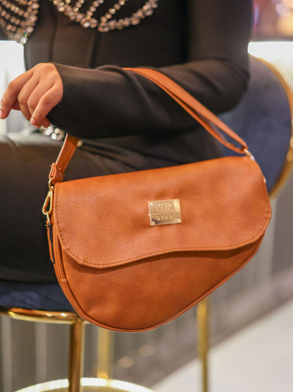 Denri Africa's spice Montana Sling Bag. Rich earthy-tone sling, vegan leather, stylish crossbody.